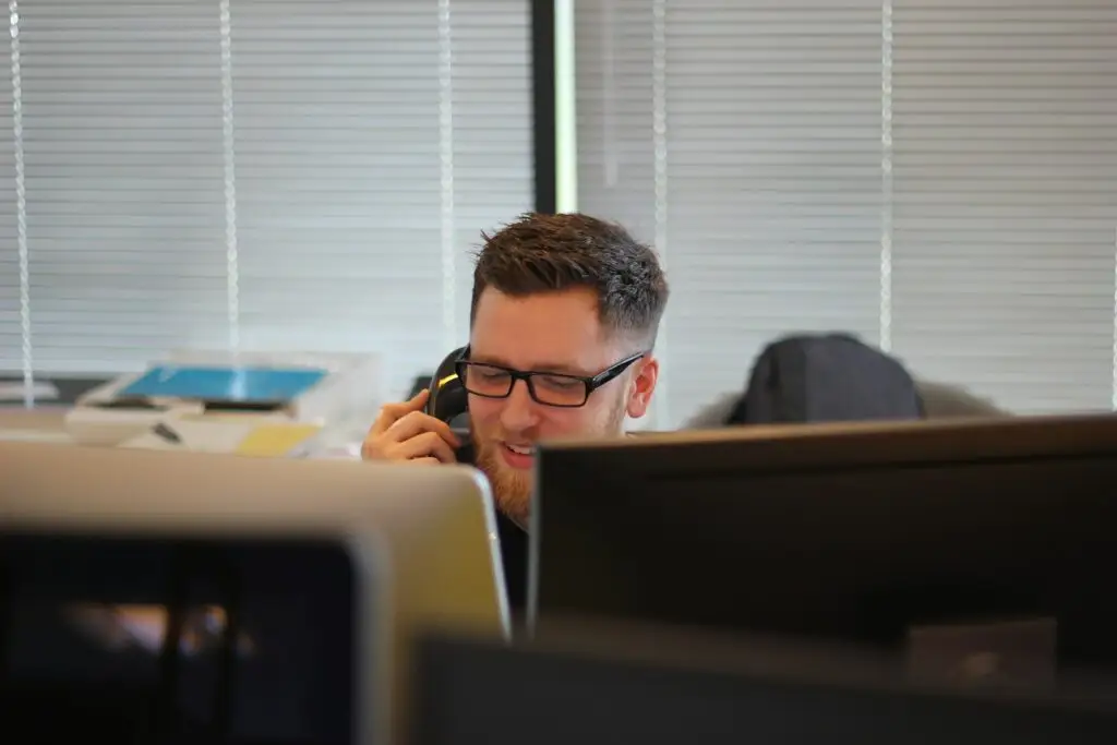 Consultant making a call on an office phone