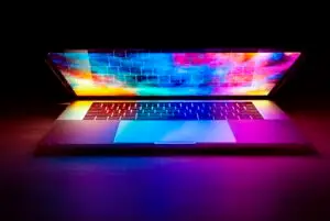 Laptop with a bright screen on a wooden desk