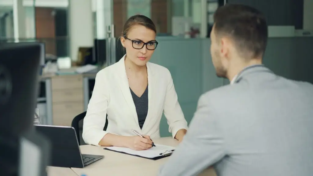Recruiter interviewing a candidate at an office desk