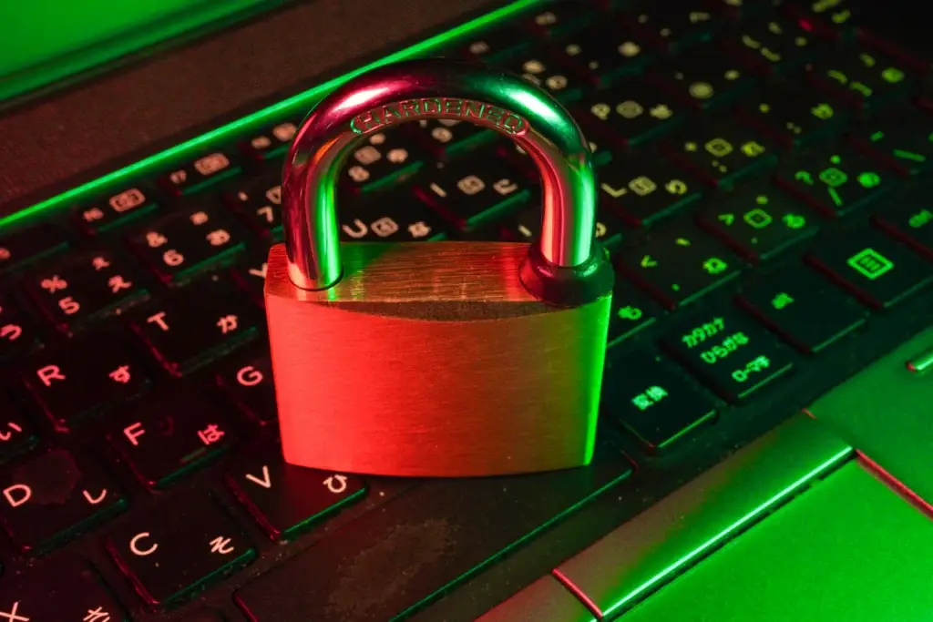 Red padlock on a black keyboard representing penetration testing and cyber security