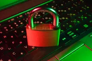 Red padlock on a black keyboard representing penetration testing and cyber security