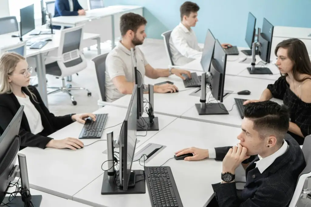 Team working at computers around a table