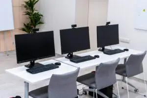Windows 11 24H2 end of support: row of office desktop workstations ready for updating